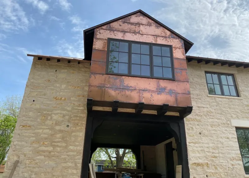 Copper metal panel facade on a stone building for Metal Roof Coating in White Bear Lake